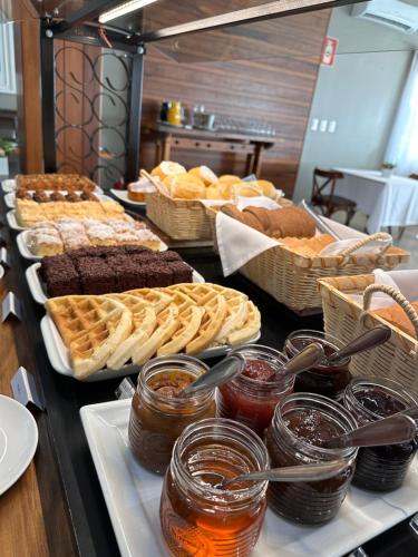a buffet line with many different types of food at Lagoa Parque Hotel in Lagoa Vermelha