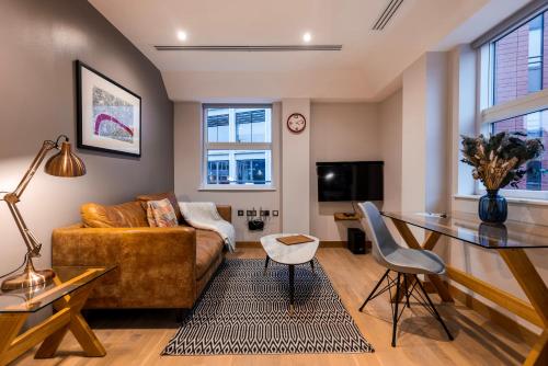 a living room with a couch and a table at Barbican Serviced Apartments by LovelyStay in London