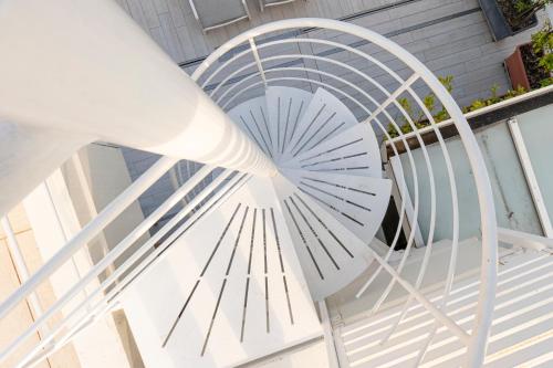 a white spiral staircase with a glass ceiling at Room Capri in SantʼAntonio Abate