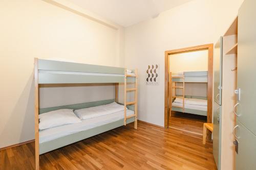 a room with bunk beds and a mirror at Wombat's City Hostel Leipzig in Leipzig