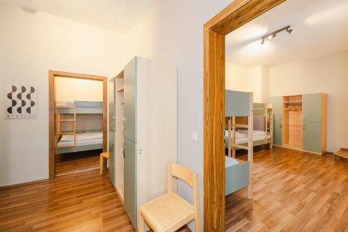 a room with a mirror and a room with bunk beds at Wombat's City Hostel Leipzig in Leipzig