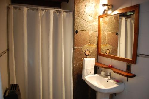 a bathroom with a shower curtain and a sink at La Cabañita in San Martín de los Andes