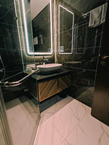 a bathroom with a sink and a mirror at 5-star class warm apartment in Ðông Khê