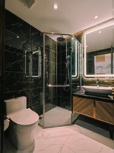 a bathroom with a toilet and a shower and a sink at 5-star class warm apartment in Ðông Khê