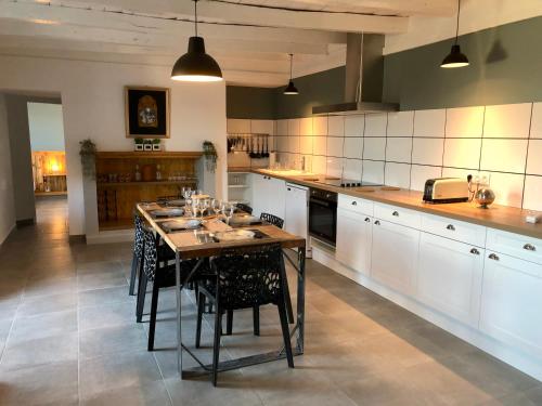a large kitchen with a table and chairs in it at Location vacances dans le Périgord vert in Saint-Front-la-Rivière