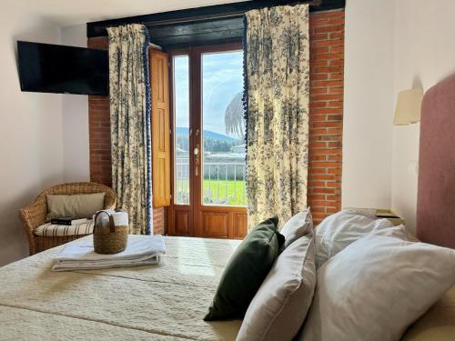 a bedroom with a bed and a large window at La Casita Azul - 1003 in Arnuero
