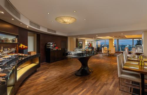 a restaurant with a bar with a view at Radisson Blu Hotel Bucharest in Bucharest