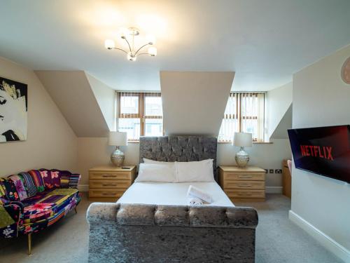 a bedroom with a bed and a couch at 2 bedroom exclusive house in Sheffield in Sheffield