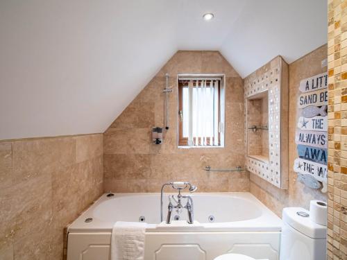 a bathroom with a tub and a sink at 2 bedroom exclusive house in Sheffield in Sheffield