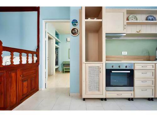 a kitchen with a stove top oven in a kitchen at Hotel Glaros Karpathos in Diafani