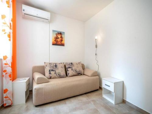 a living room with a couch in a room at Apartments Matija in Vodice