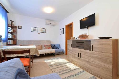 a living room with a flat screen tv on the wall at Apartment Pia Murter in Murter