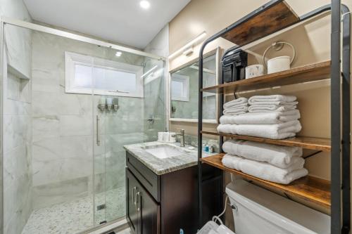 a bathroom with a shower and a sink at 7 Bed Haven Sleeps 12 20Min to NYC Massage Chair in Bayonne