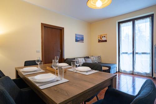 a dining room with a wooden table and chairs at Valley Hideaway with private garden near Como lake in Taceno