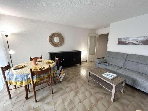 un salon avec une table et un canapé dans l'établissement Appartement T3 avec terrasse et garage proche mer – Saint-Raphaël - FR-1-226A-146, à Port Santa-Lucia