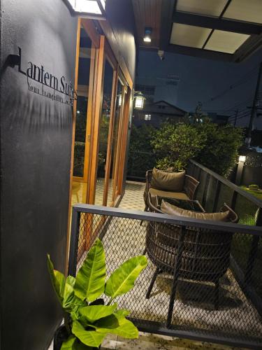 a balcony of a building with chairs and plants at The Lantern Suites in Ban Song Hong