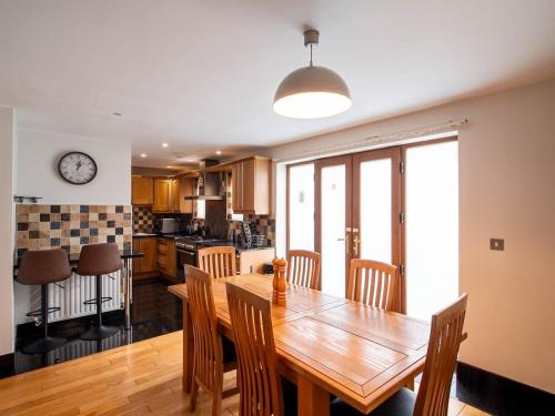 a kitchen and dining room with a wooden table and chairs at Exclusive 3-Bedroom Villa in Sheffield in Sheffield