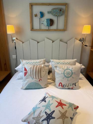 a bedroom with a bed with pillows at Face aux Flots in La Cotinière