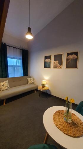 a living room with a couch and a table at Babie Lato b&b in Uniejow