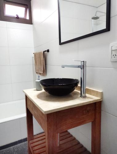 a bathroom with a black bowl sink on a counter at Amplio y cómodo - Excelente ubicación in Mendoza
