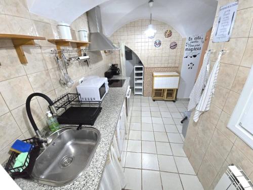 a kitchen with a sink and a counter top at La morada del maestre in Cáceres