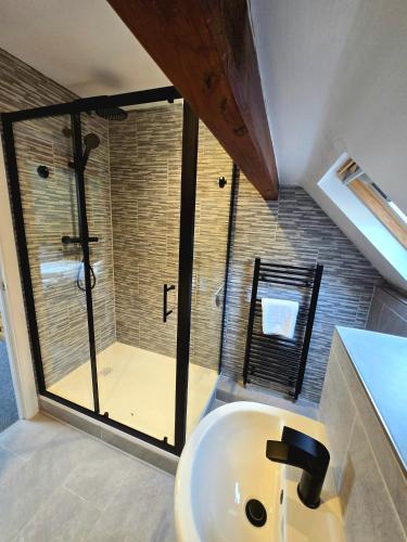 a bathroom with a sink and a shower at Birch Cottage in Hope