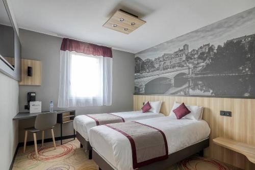a hotel room with two beds and a desk and a painting at Brit Hotel Le Cottage Le Mans Sud in Arnage