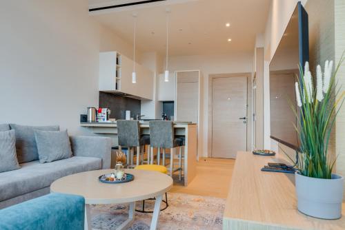 a living room with a couch and a table at ZEPTERME Luxury Apartments & Studios by CENTRAL in Vrnjačka Banja