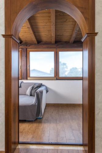 a bed in a room with two windows at Un posto in Fiera in Rome