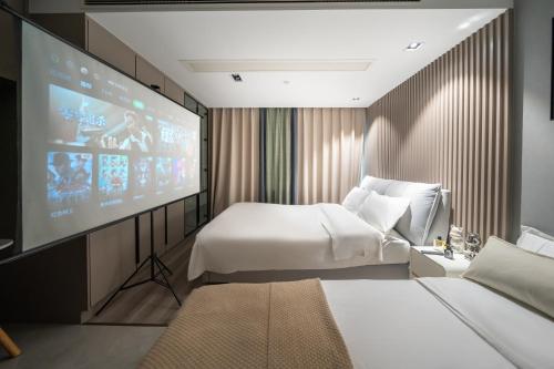 a hotel room with two beds and a projection screen at Today Aparthotel West Lujiazui Shanghai in Shanghai