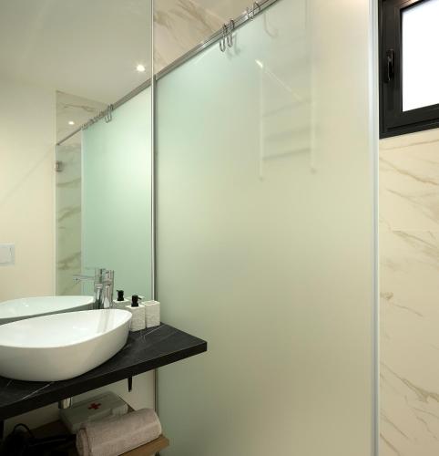 a bathroom with a sink and a mirror at Marco 4 Seasons- Spring in Arco da Calheta
