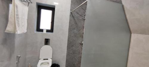 a bathroom with a toilet and a window at Majestic Shamakhi A-Frame in Kirovka