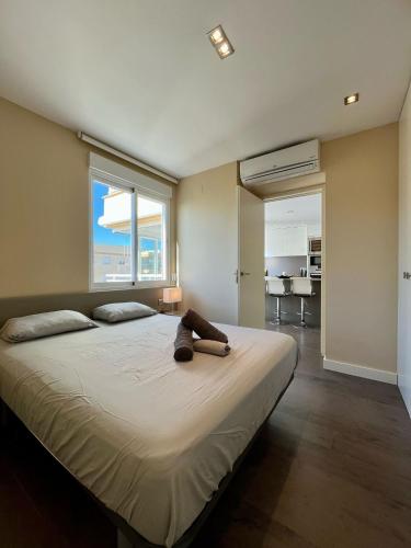 a large bed in a bedroom with a large window at El Horizonte de Benicassim II, Descubre esta lujosa propiedad a los pies del Mediterraneo in Benicàssim