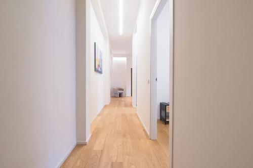 a hallway with white walls and a wooden floor at Missori Luxury Apartments in Milan