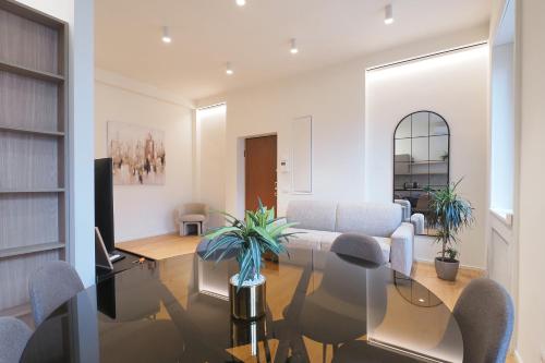 a living room with a glass table and chairs at Missori Luxury Apartments in Milan