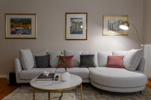 a living room with a couch and a table at HouSmart Lorenzo Costa 17 in Bologna