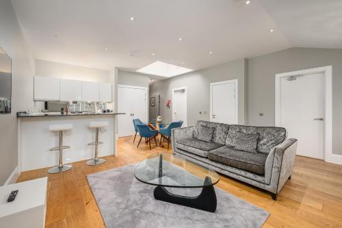 a living room with a couch and a table at Destiny Scotland - St Andrew Square Apartments in Edinburgh