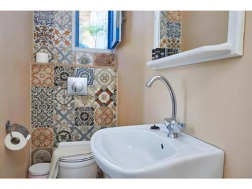 a bathroom with a sink and a toilet at Hotel Glaros Karpathos in Diafani