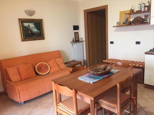 a living room with a couch and a table at Piccolo angolo di paradiso in Roncola