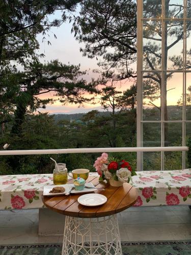 a table with flowers on top of a balcony with a view at 163 Sqm Luxury Spacious Modern European Cott-age Style 3 Bedrooms With 2 Parkings in Baguio