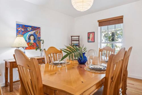 a dining room with a wooden table and chairs at Tranquil Heirloom Hideaway Pool in South Miami in Miami