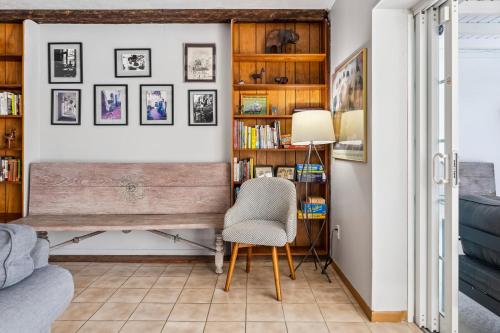 a living room with a bench and a chair at Tranquil Heirloom Hideaway Pool in South Miami in Miami