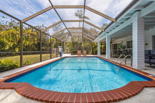 an indoor swimming pool with a glass roof at Tranquil Heirloom Hideaway Pool in South Miami in Miami
