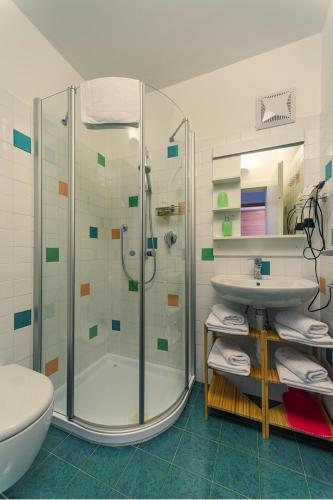 a bathroom with a shower and a toilet and a sink at Apartment Le rose di Marianne - sud in Varna