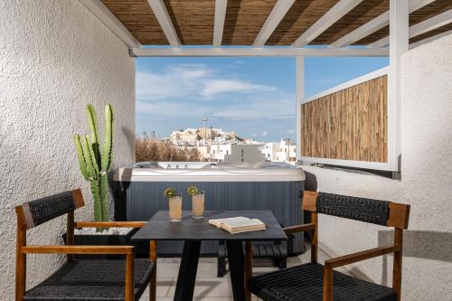a table and chairs on a balcony with a view at Anatoli Hotel in Naxos Chora