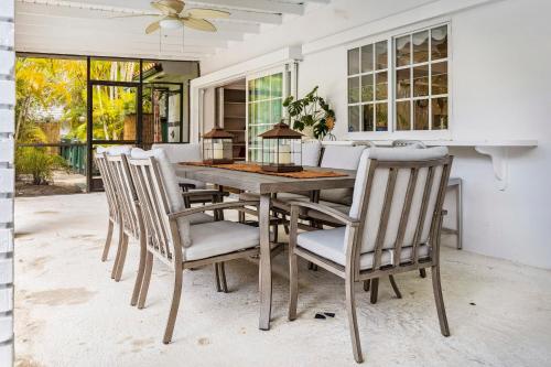 a dining room with a wooden table and chairs at Tranquil Heirloom Hideaway Pool in South Miami in Miami
