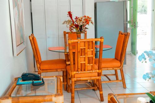 a dining room with a glass table and chairs at Bellavista Scott Hotel in Charlotte Amalie