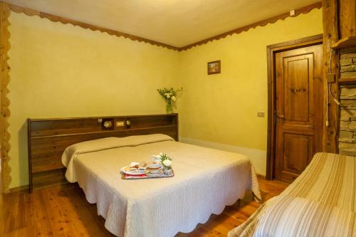 Cama o camas de una habitación en Albergo Boule de Neige
