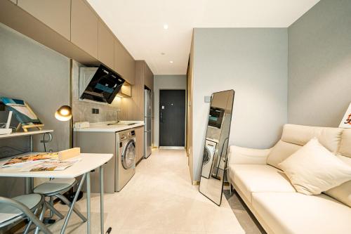 a small living room with a couch and a table at Today Aparthotel West Lujiazui Shanghai in Shanghai