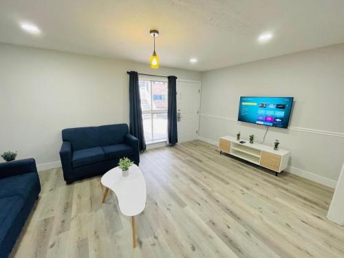 a living room with a couch and a tv and a table at Perfect Vacation walk to the beach 9 in Myrtle Beach